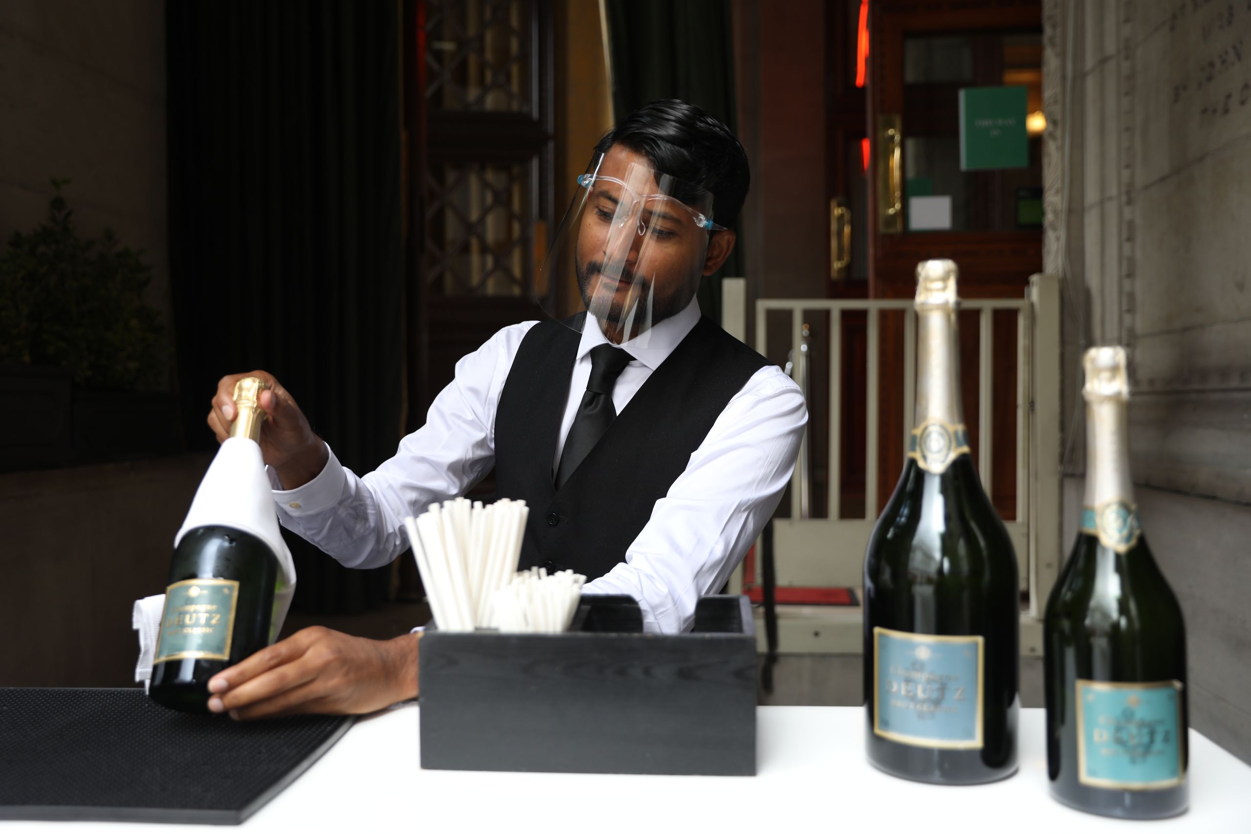 A sommelier wears a face shield at restaurant 1 Lombard Street in the City of London.